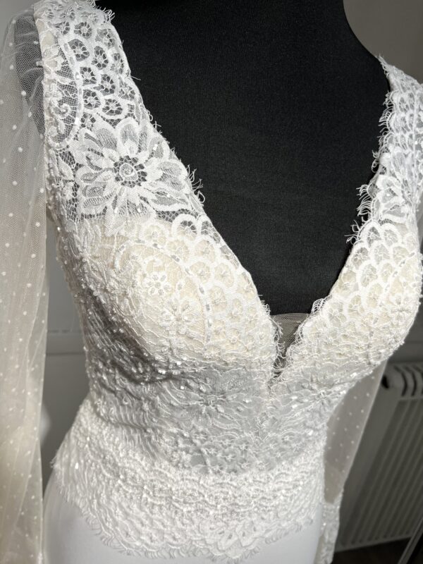 Robe de mariée Naray – Dentelle, décolleté en V et jupe fluide en crêpe.