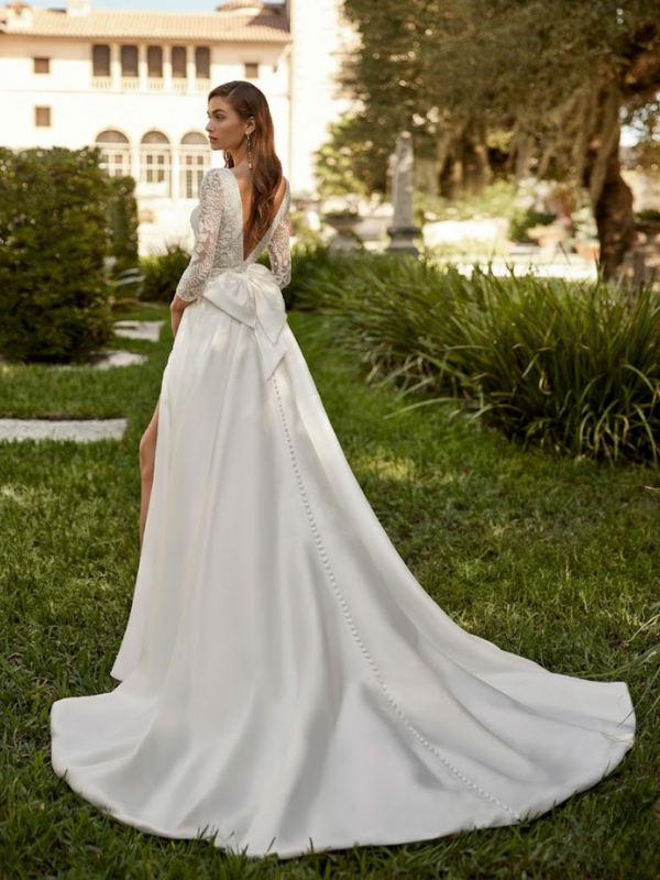 Vue de dos de la robe de mariée princesse Suna en mikado de la marque Aire Barcelona, montrant les détails de boutonnage et la traîne.