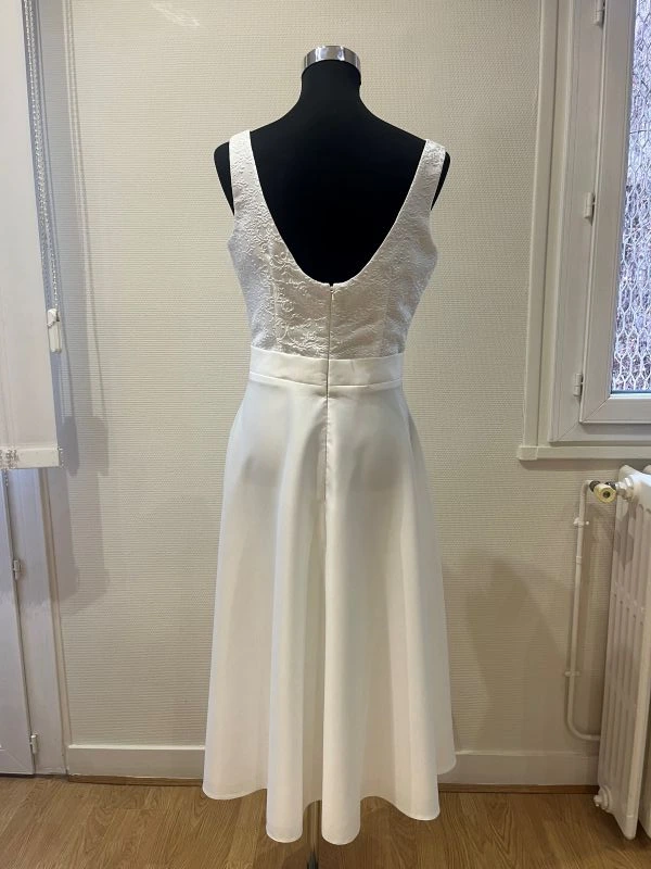 Robe de mariée courte modèle Alessia par Allen Rich en taille 44, vue de dos entière sur mannequin montrant le grand décolleté dos nu en U et la jupe en crêpe.